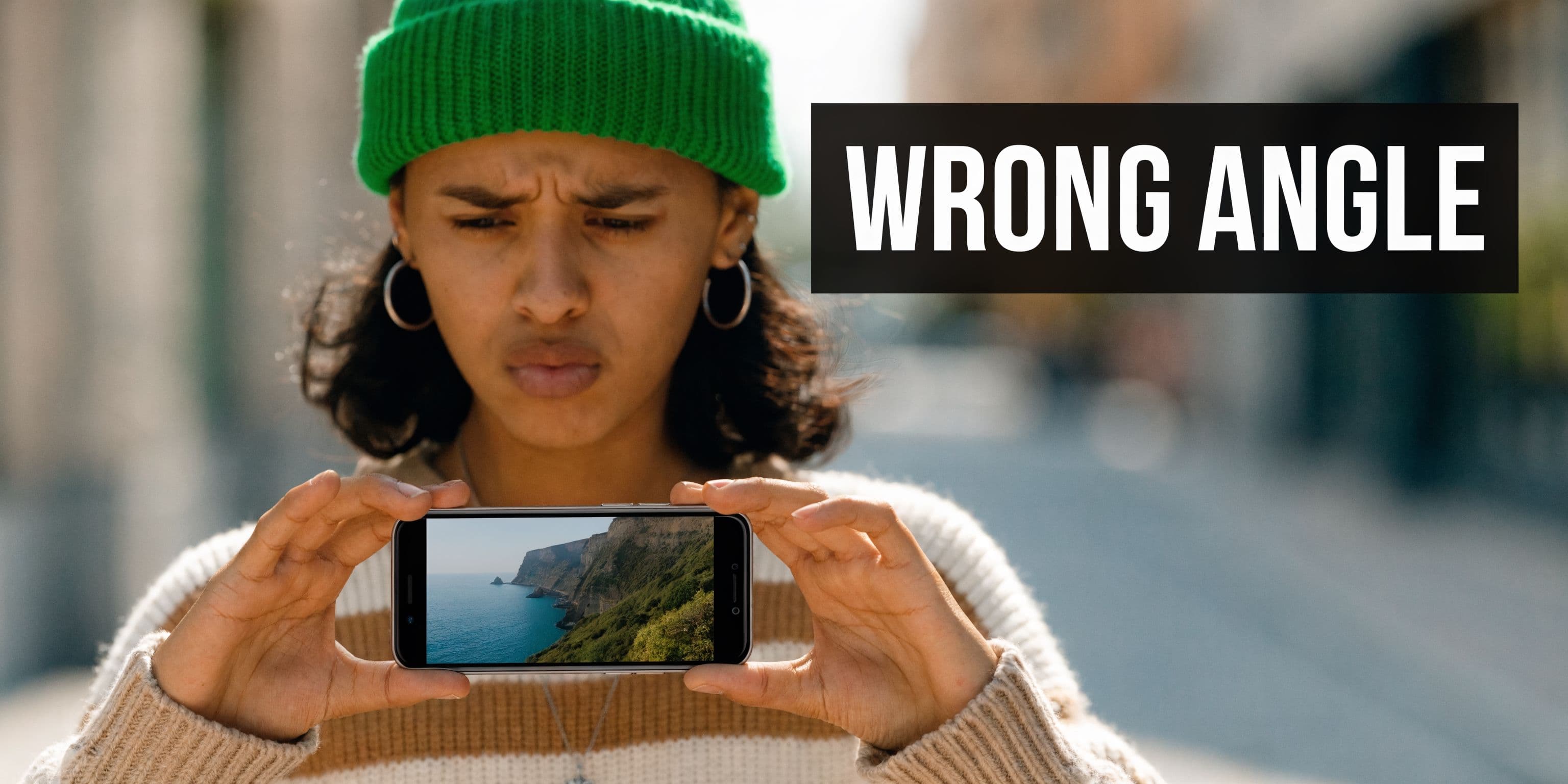 A person looking confused at a smartphone displaying a video with an incorrect portrait orientation.
